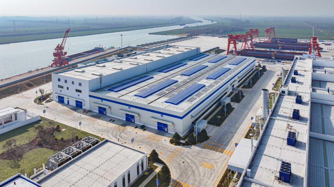 Modern industrial facility with cranes and containers