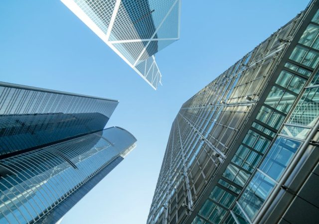 Modern skyscrapers captured from below, showcasing Hong Kong's urban architecture.
